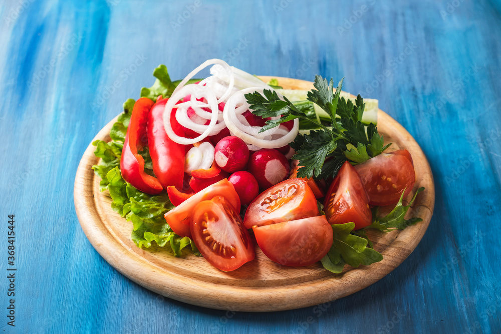 Vegetables plate. Different fresh vegetables on wooden board. Cold snack Vegetables plate. Different fresh vegetables on wooden board. Cold snack