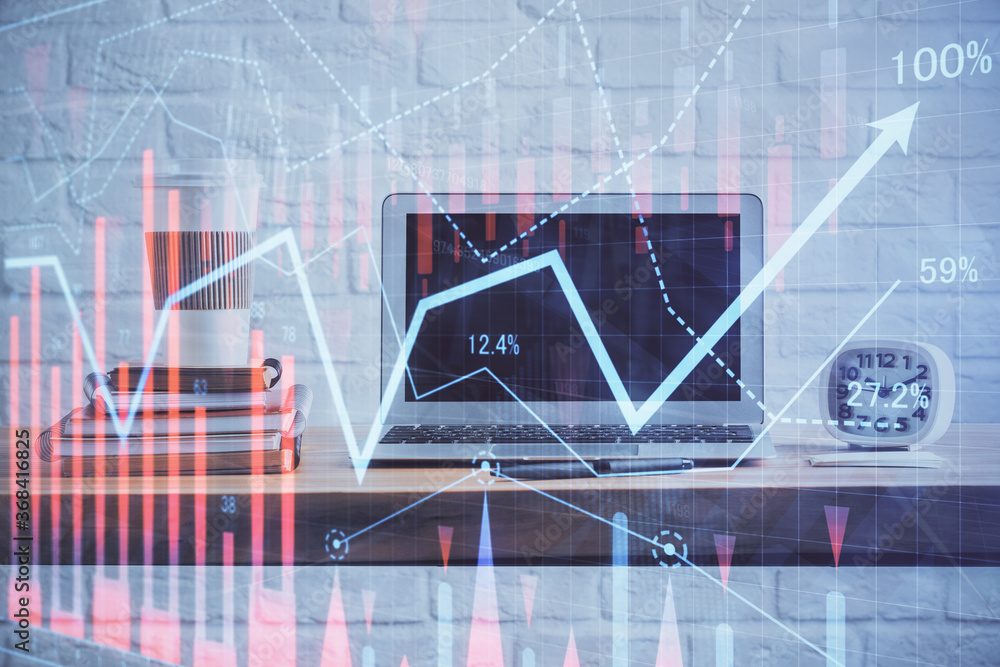 Stock market chart hologram drawn on personal computer background. Multi exposure. Concept of investment. Stock market chart hologram drawn on personal computer background. Multi exposure. Concept of investment.