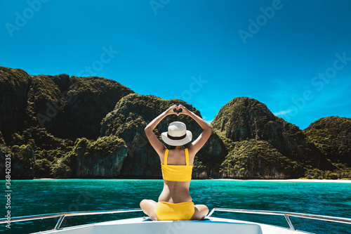 Traveler asian bikini woman relax and travel on boat in Maya Bay Phuket Thailand