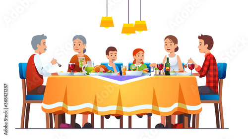 Family at full laid table celebrating thanksgiving