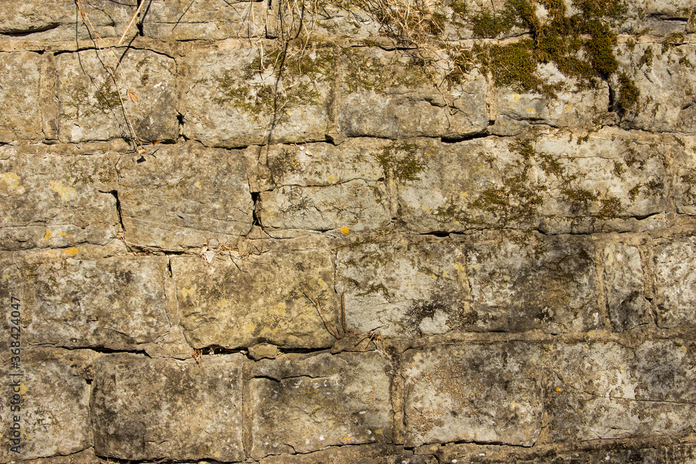 Close-up of masonry on an old stone wall covered with moss. Close-up of masonry on an old stone wall covered with moss.