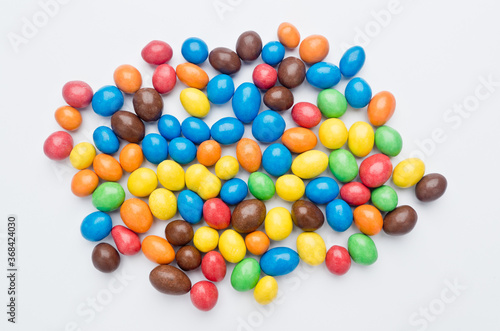 Colored candies filled with chocolate. On white background