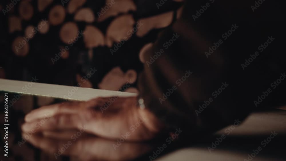 Old man drawing a line with a pencil along a mirror Old man drawing a line with a pencil along a mirror
