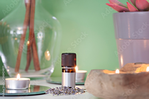 Spa still life with cinamon sticks, lavender oil and candles photo