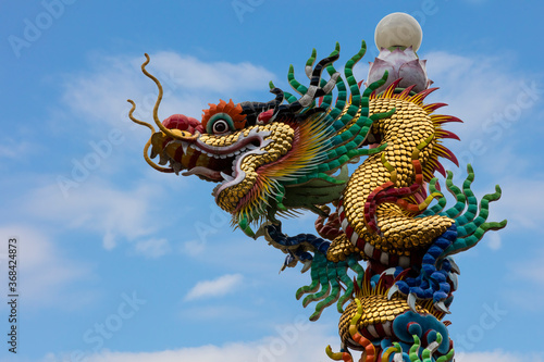 Chinese Golden Dragon Statue on sky background