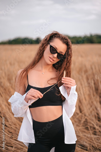Portrait of sensual brown-haired girl in wheat