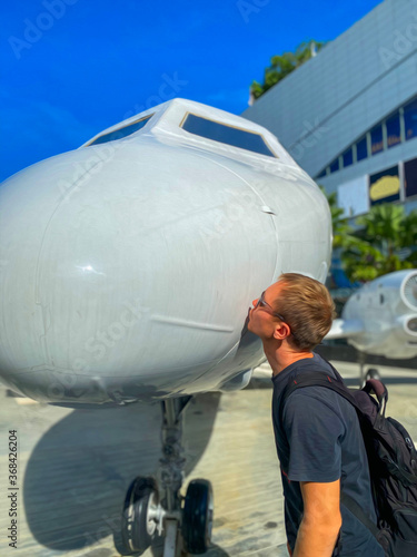 person with airplane. Men kiss the plane