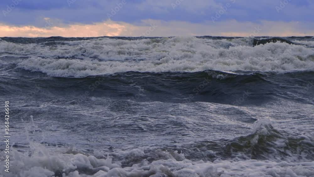 Waves at sea during a thunderstorm at sunset Waves at sea during a thunderstorm at sunset