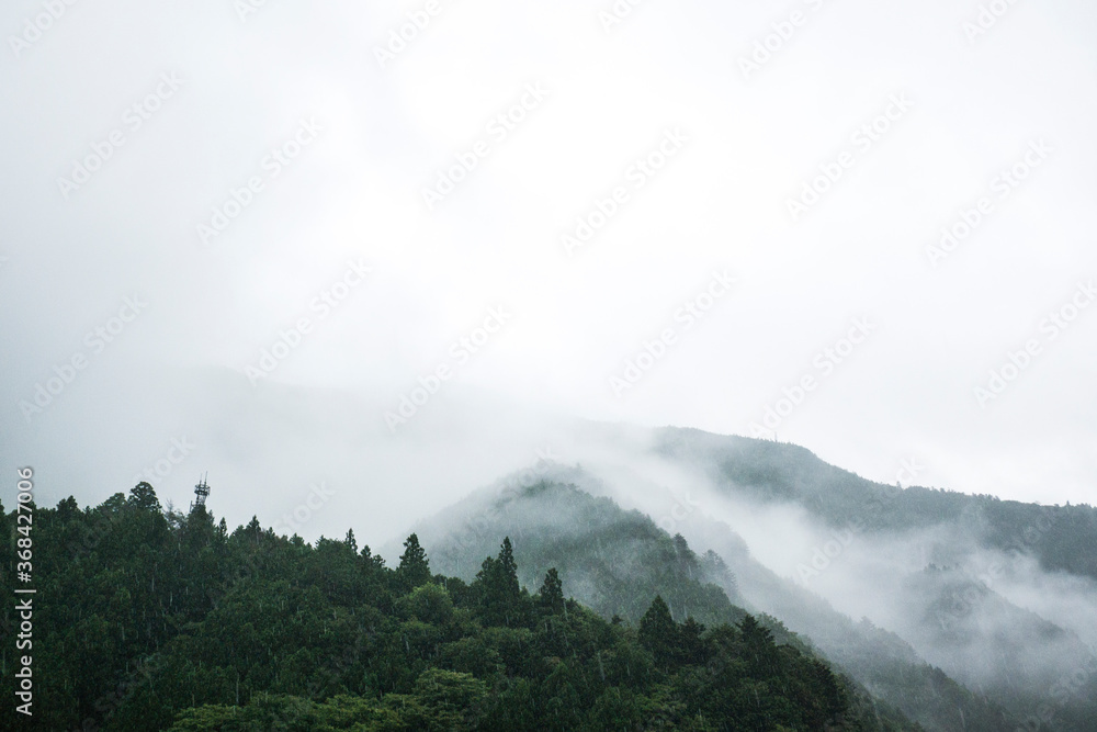 大雨で霧のかかった山