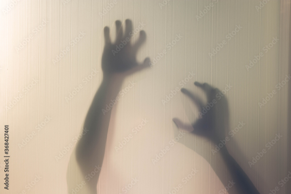 Silhouette of arms and hands behind curtain with soft focus and blur. Silhouette of arms and hands behind curtain with soft focus and blur.