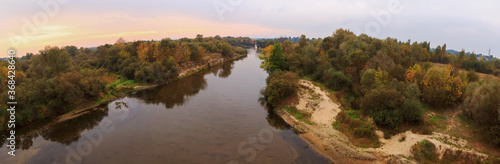 panorama of a small river at dawn in summer