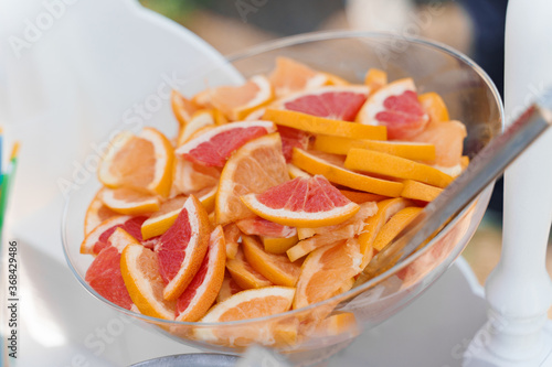 Plate with grapefruits and oranges on wedding. Starter food.