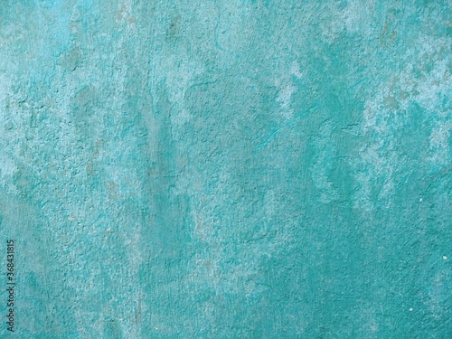 Old grungy wall background with blue paint color. Blue Wall with peeling paint background texture.