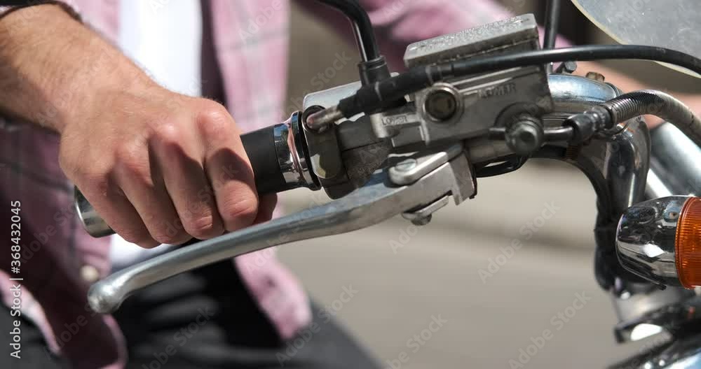 Man accelerating and starting his motorcycle on road Stock Video Adobe Stock