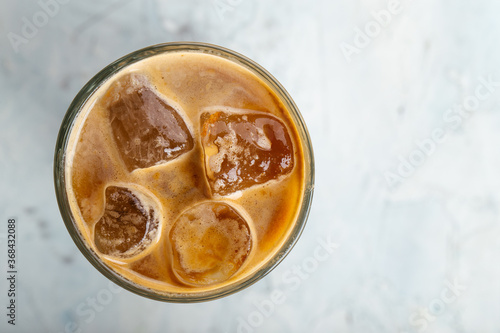 Iced coffee in a glass on the blurry background