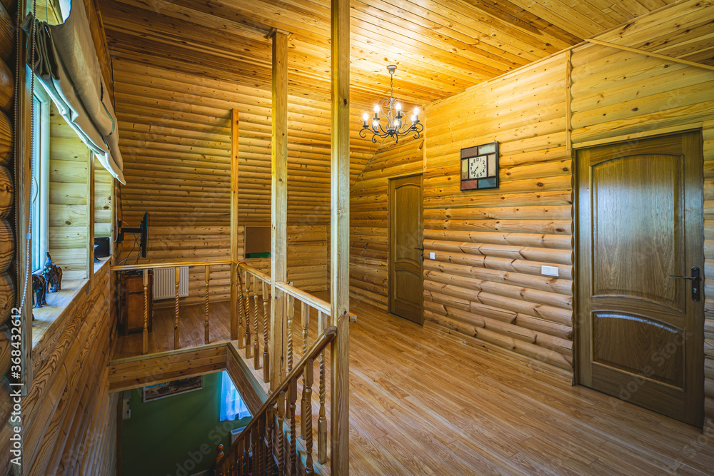Fototapeta premium Wooden eco interior of private country house. Hall on the second floor.