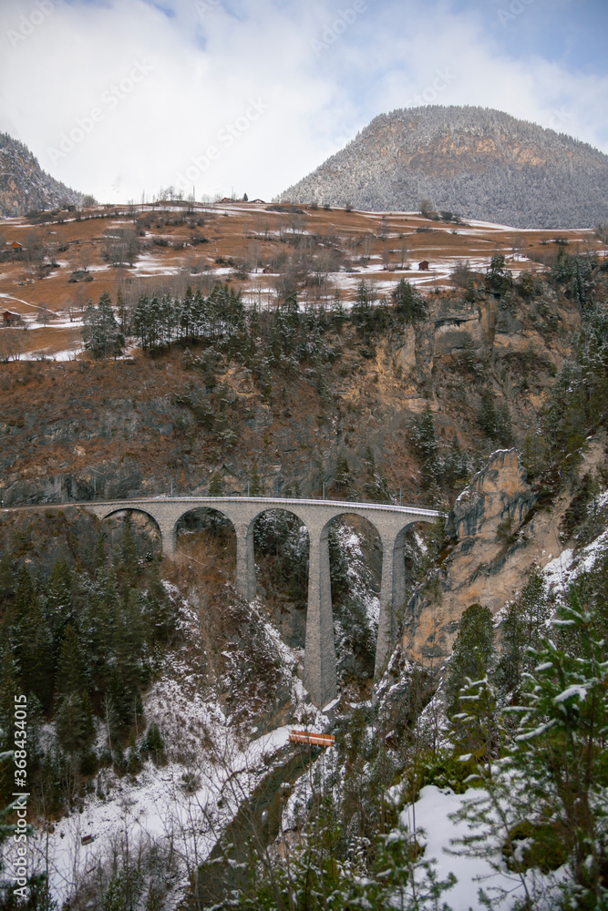 Beautiful Landwasser Viaduct in Switzerland in overcast day, snowfall Beautiful Landwasser Viaduct in Switzerland in overcast day, snowfall