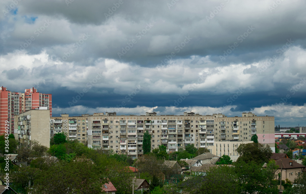 View of the city with big dark clouds. Wallpaper of nature