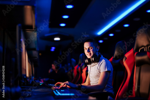 Portrait of a young professional gamer at cybercafe.