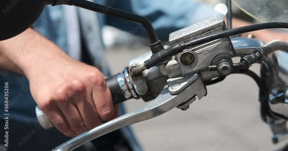 Hand of man holding motorcycle accelerator Hand of man holding motorcycle accelerator
