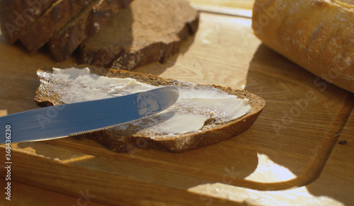 Hand smearing bread with butter