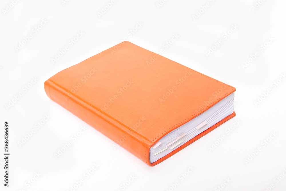 Orange notepad with bookmarks on white background Orange notepad with bookmarks on white background