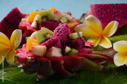 Dragon fruit (Pitaya, Pitahaya).Sliced pieces pitahaya fruit and fruit salad,and frangipani flowers.