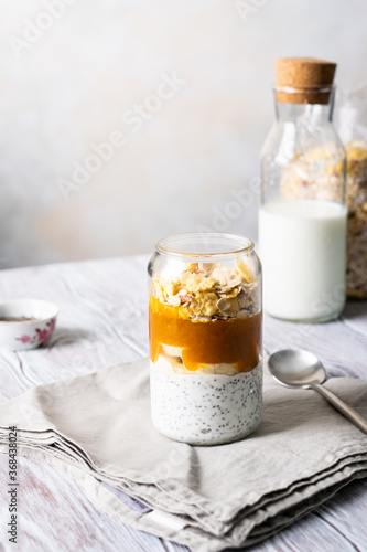granola with yoghurt and fruit puree in a glass glass