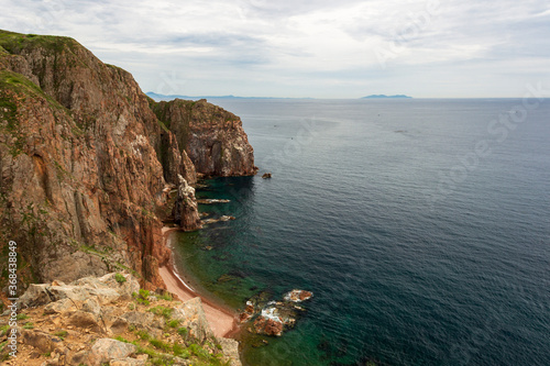 View of the Peter the Great Bay from the rocks at the southern tip of Shkot Island in the Vladivostok water area on a summer day.