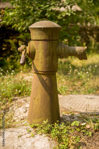 old rusty water column in the village