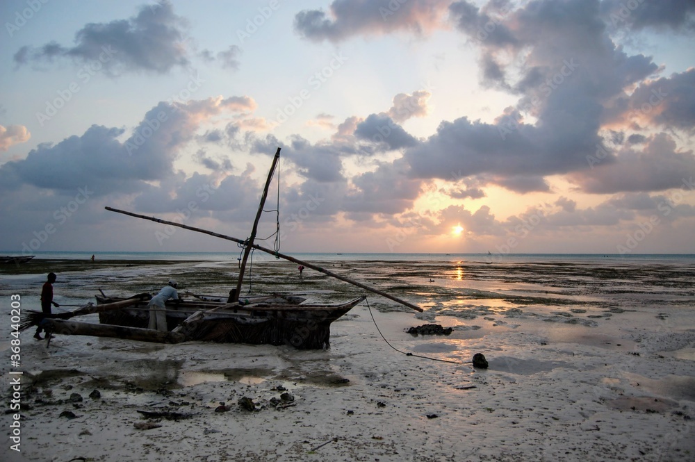 Fishermen preparing their boat at sunrise in Jambiani, Zanzibar