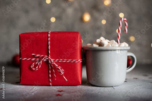 Mugs with hot drink and gingerbread cookie.