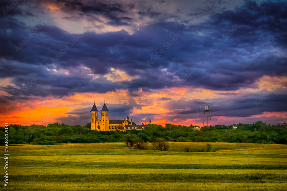 Panorama View of the Midwest Wheat Field Prairie and Cathedral of the Plains in Victoria Kansas USA in Sunset Sky Clouds