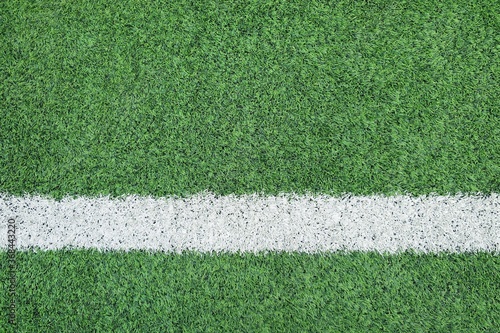 Line on Soccer field or football field texture background. White lines on green grass, symbol to the way to success. Sport and business background concept.