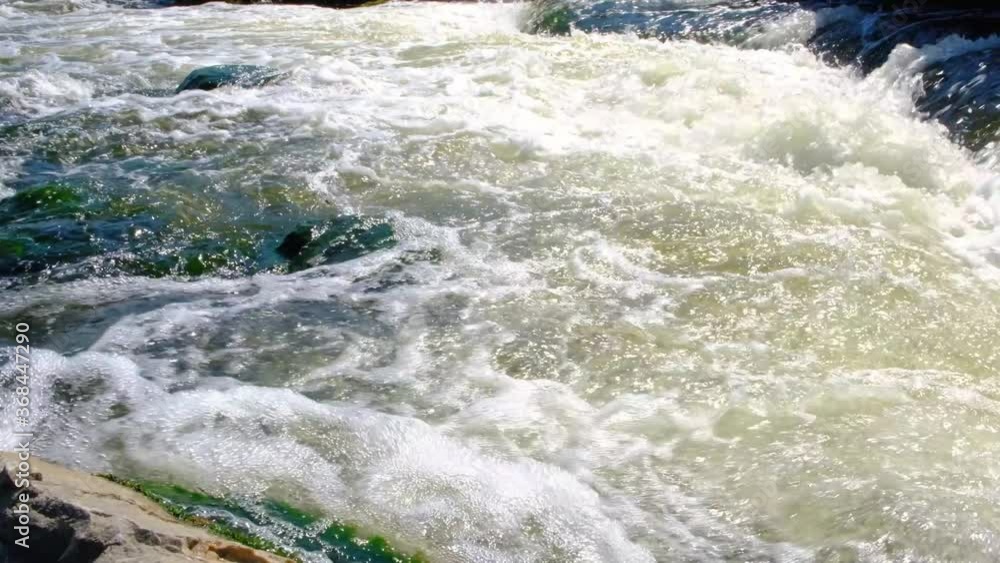 Rapid flow of water on a mountain river with underwater rapids. Rapid flow of water on a mountain river with underwater rapids.