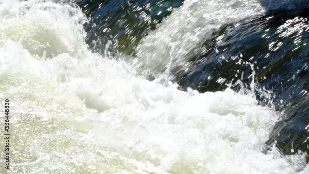 Rapid flow of water on a mountain river with underwater rapids. Rapid flow of water on a mountain river with underwater rapids.