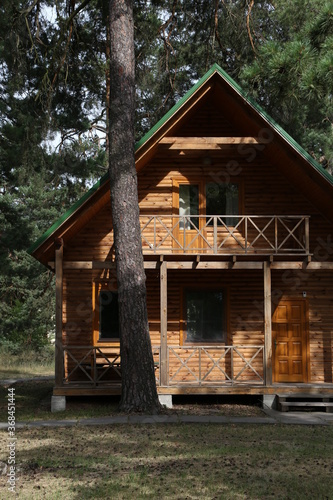 wooden house in the forest among the trees © Сергей Луговский