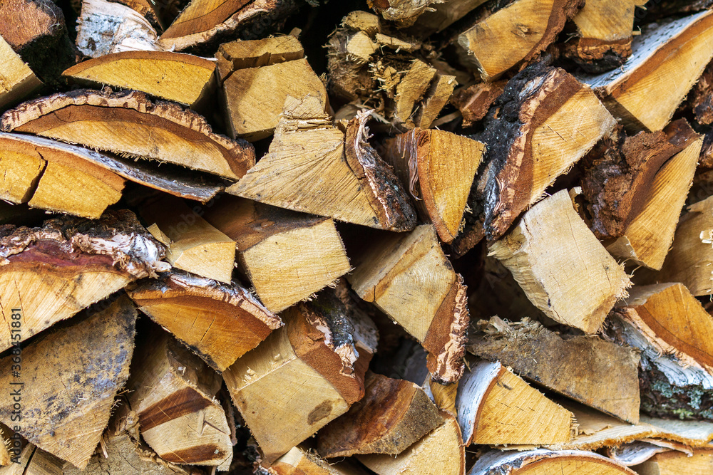 Stack of firewood, Textured of dry chopped logs for wallpaper, Natural wood background for design template.