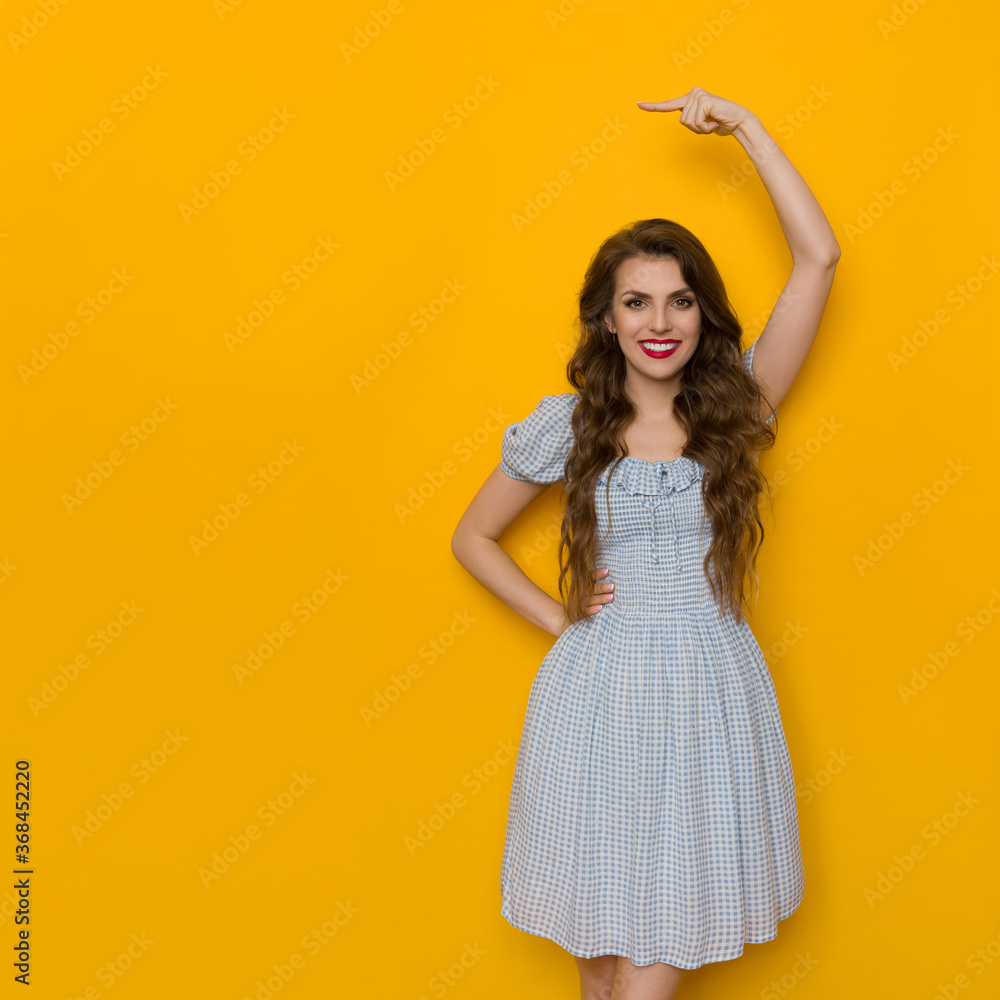 Beautiful Woman In Blue Dress In Pointing Over Head Beautiful Woman In Blue Dress In Pointing Over Head