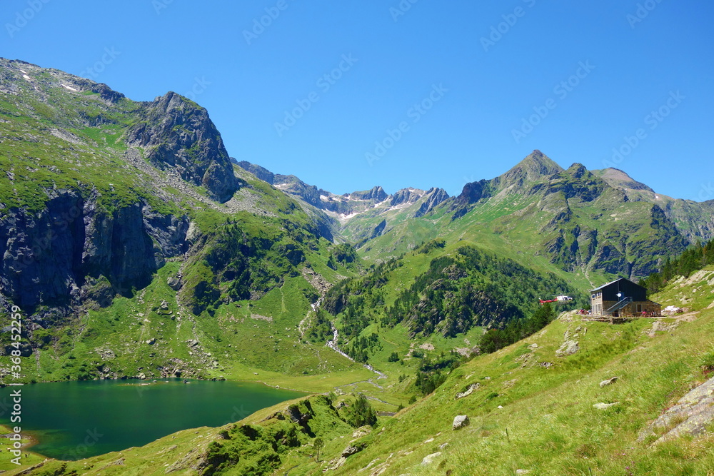 Mountain lake called d'Espingo in Pyrenees mountains on a hiking trail GR10