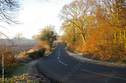 A view along a county road on a frosty morning in Essex, England, UK.