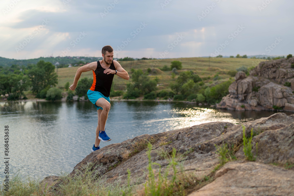 Male runner running over stones, copy of free space. Male runner running over stones, copy of free space.