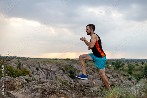 Male runner running over stones, copy of free space.