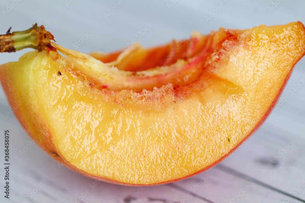 Ripe red-yellow peach is cut into wedges. Healthy eating. Fruit diet. macro Ripe red-yellow peach is cut into wedges. Healthy eating. Fruit diet. macro