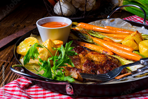 grilled neck chops with caramelized vegetables. photo