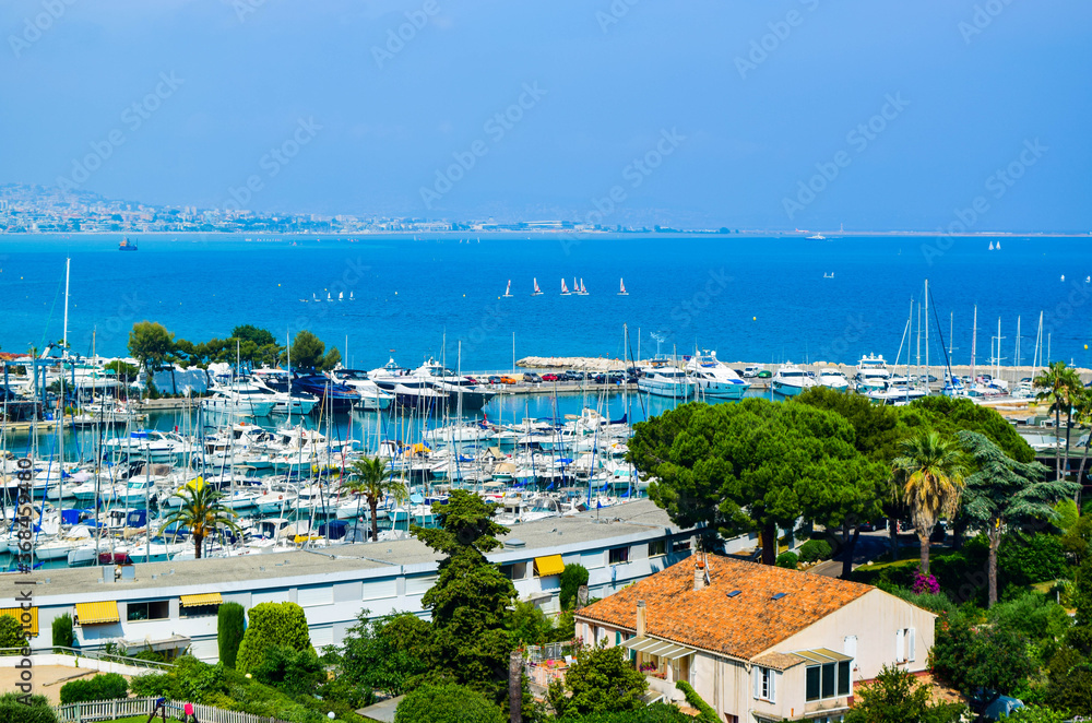 Obraz premium Landscape of the beautiful Marina Baie des Anges on against backdrop of Mediterranean Sea with yachts and sailboats. Villeneuve-Loubet. France.