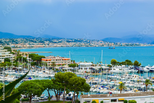 Quadro su tela Landscape of the beautiful Marina Baie des Anges on against backdrop of Mediterranean Sea with yachts and sailboats