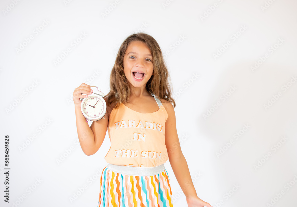 Beautiful girl with a clock on white background