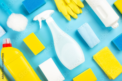 Detergents and cleaning products agent, sponges, napkins and rubber gloves, blue background. Top view