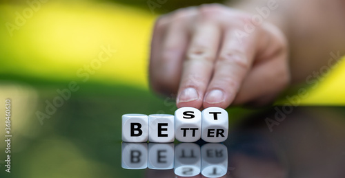 Hand turns dice and changes the word better to best.